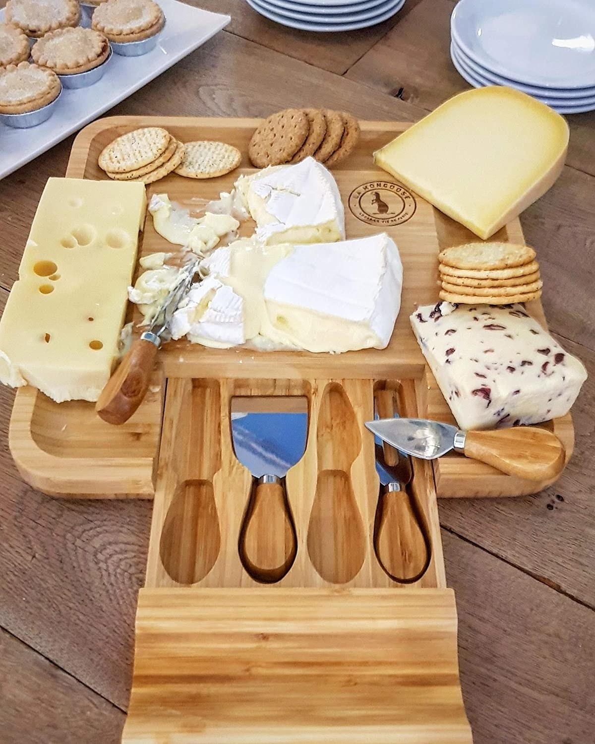 the cheese board with cheeses and the knives