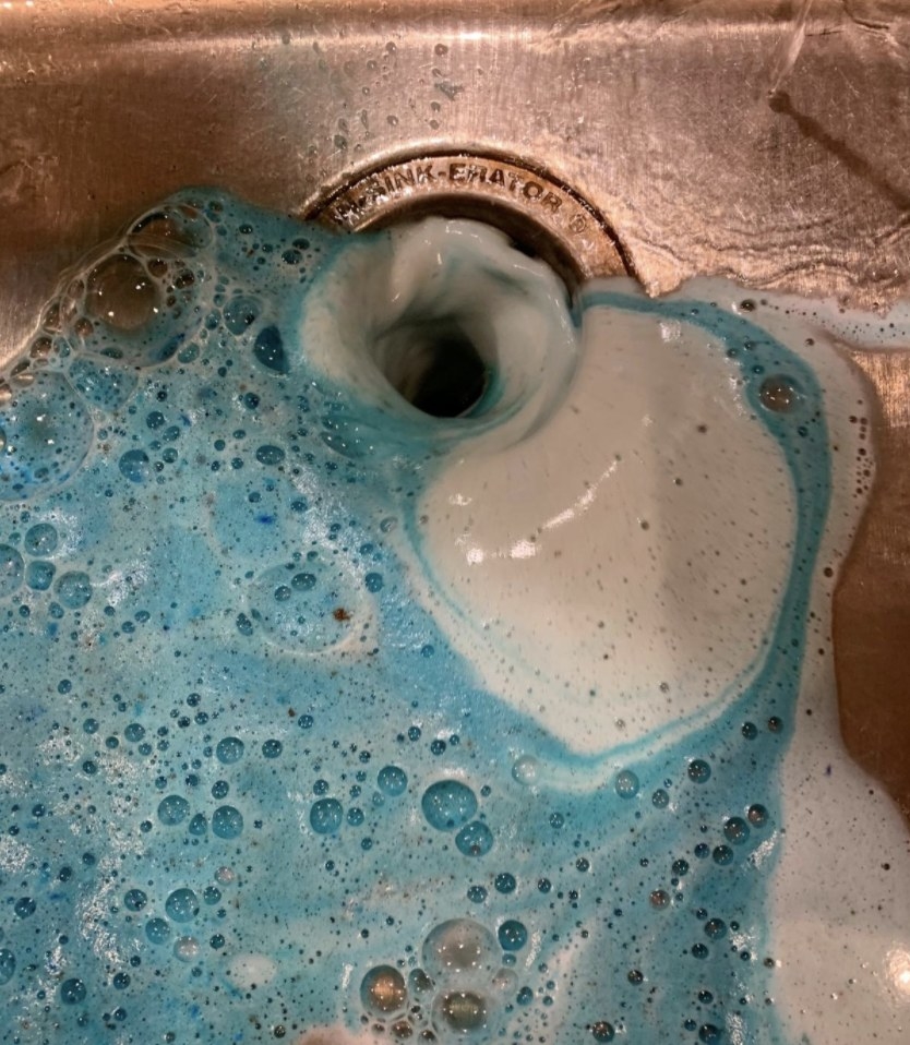 A disposal with blue foam everywhere