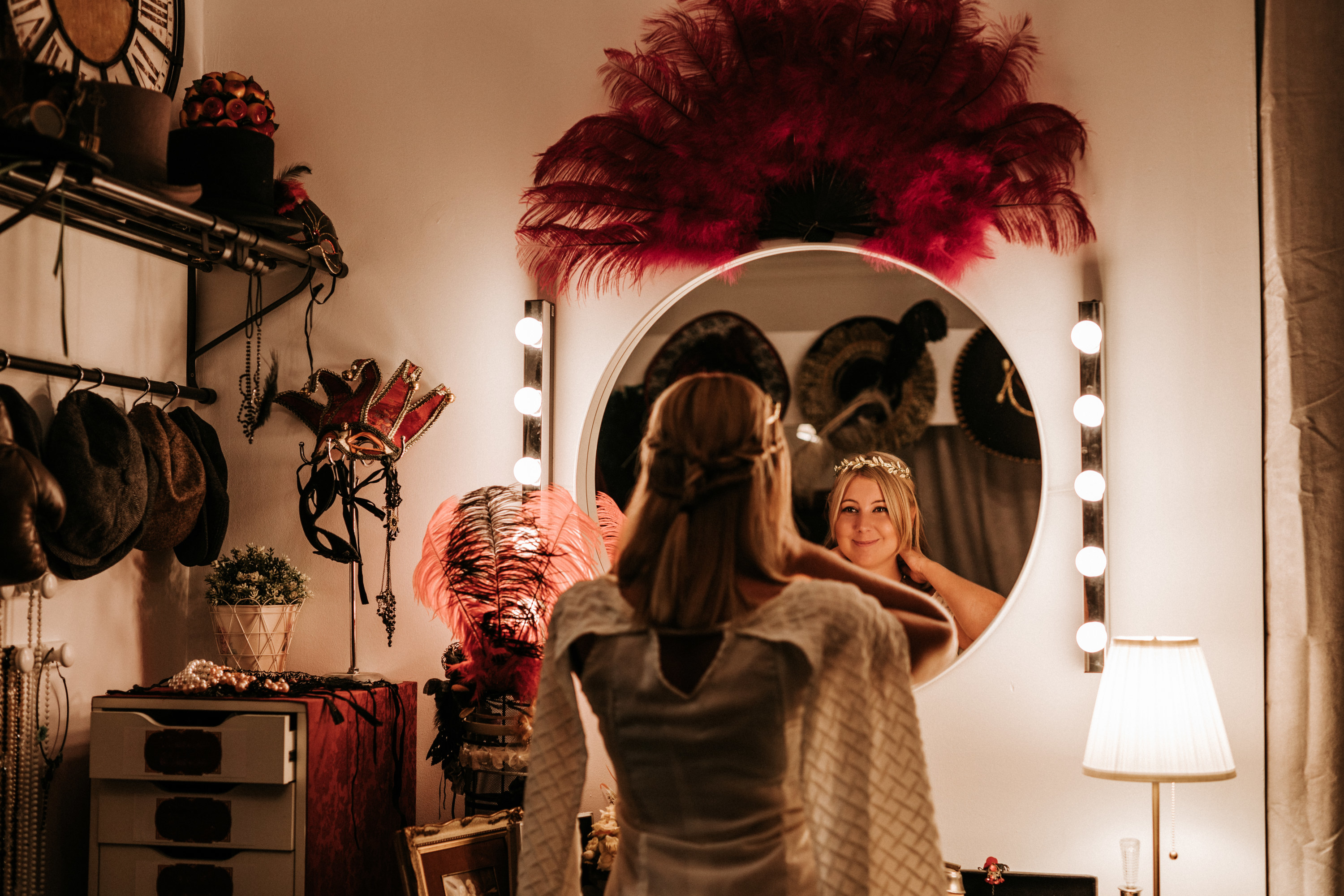 Photo of an actress on set looking in a mirror