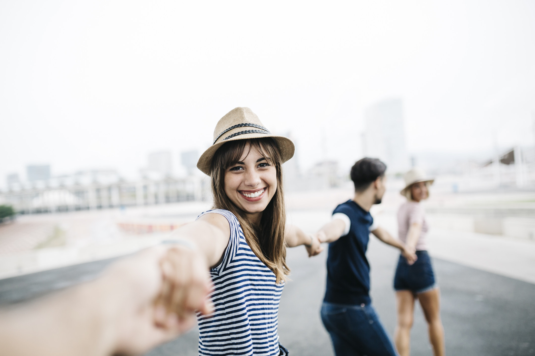 A group of friends holding hands and smiling