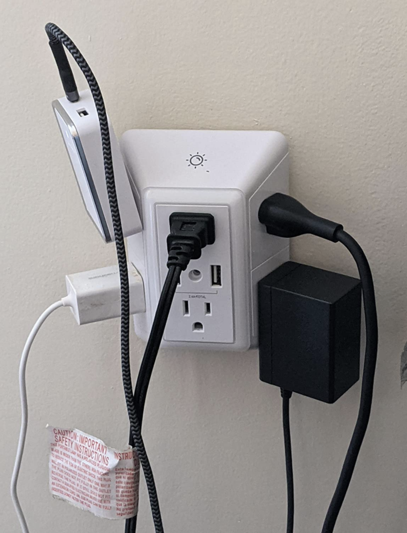A reviewer&#x27;s smart plug with five devices plugged in