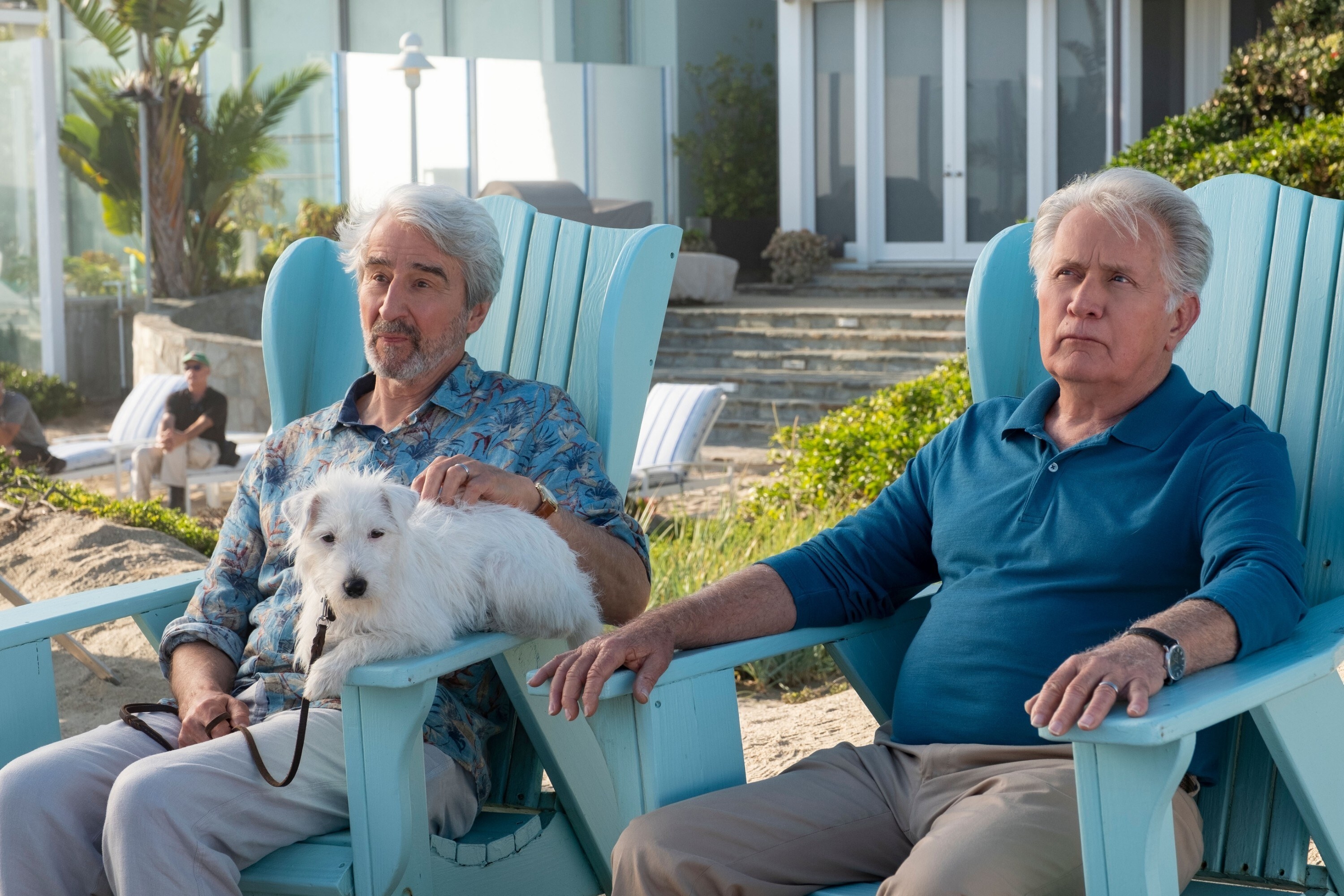 Sam Waterston and Martin Sheen in Adirondack chairs with their dog