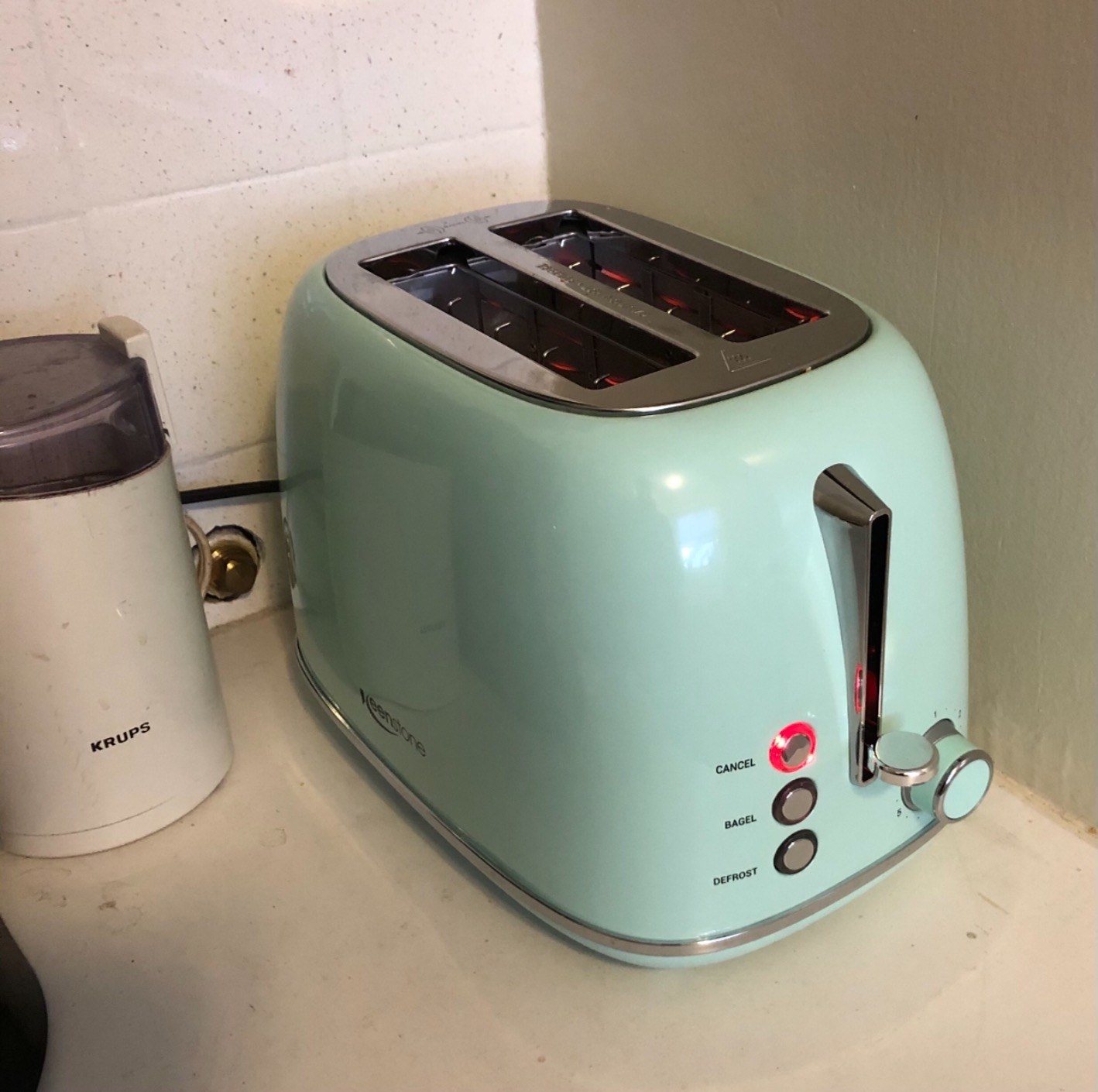 A reviewer photo of the toaster in green