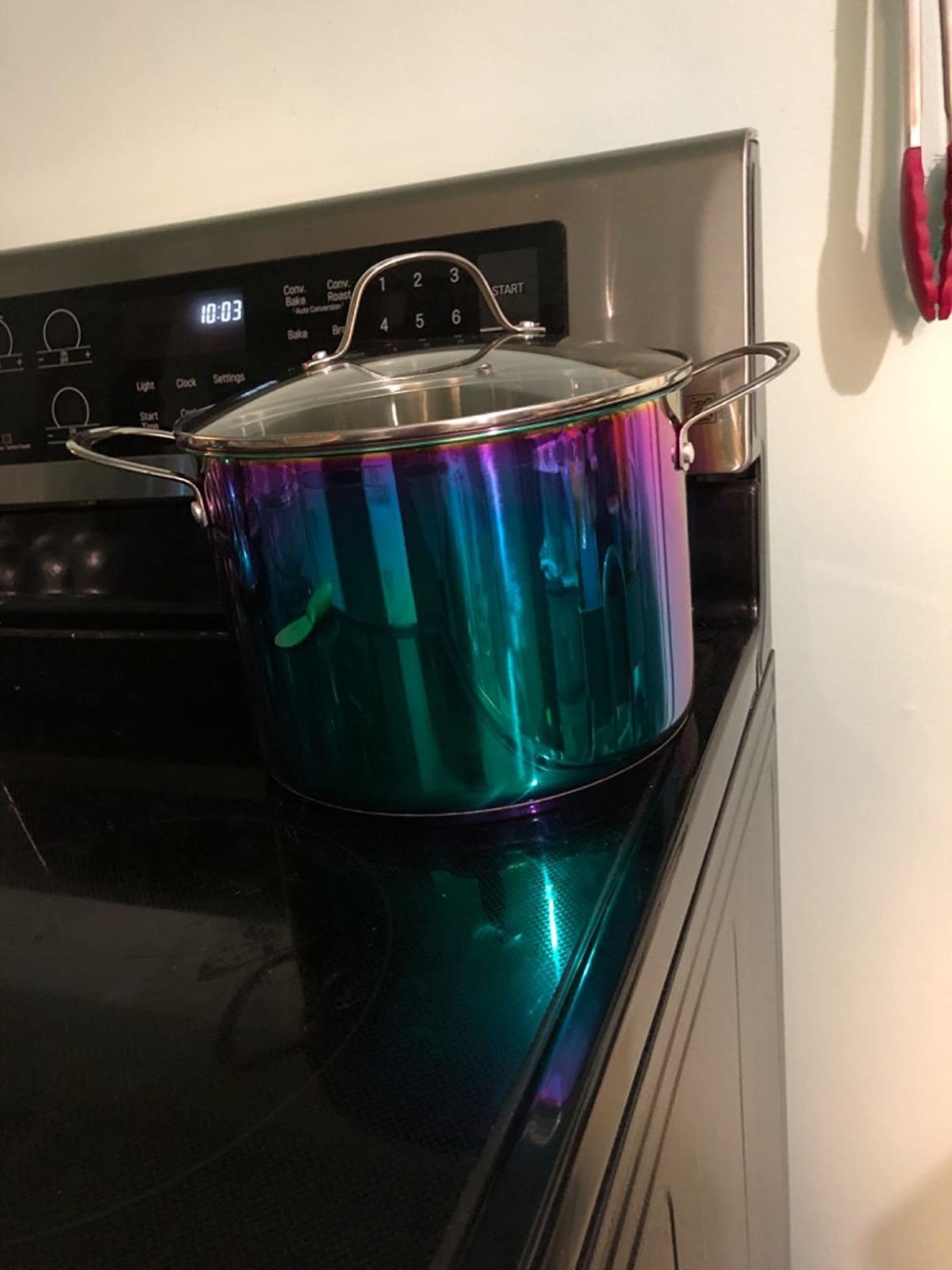 A reviewer photo of the pot, which has riveted handles and a rainbow-shimmer metallic color
