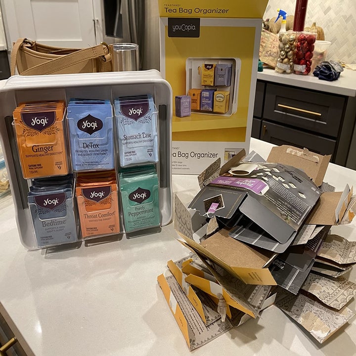 Reviewer photo of the organizer next to a stack of flattened tea boxes 