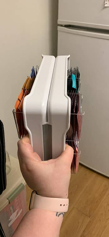 Reviewer holding the organizer and showing how slim it is