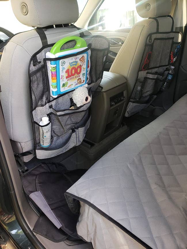 Reviewer photo of the organizers in a car holding baby supplies