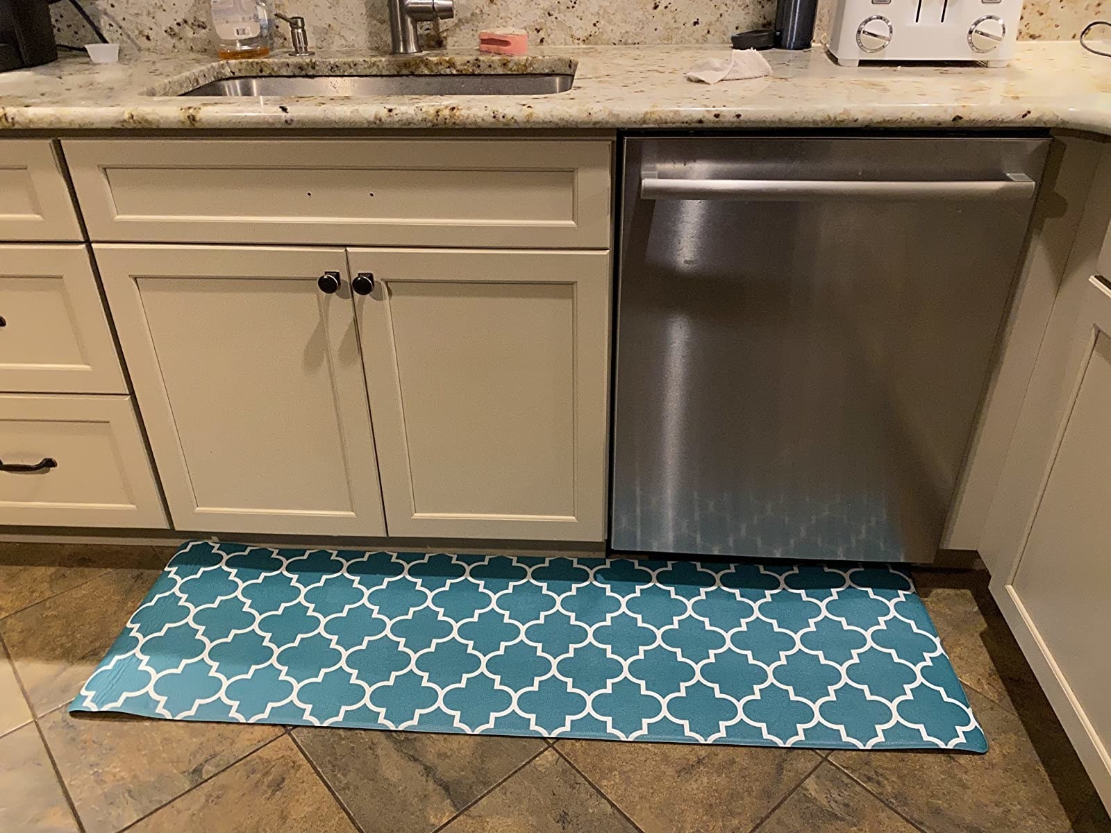 A reviewer photo of the rug in turquoise and white
