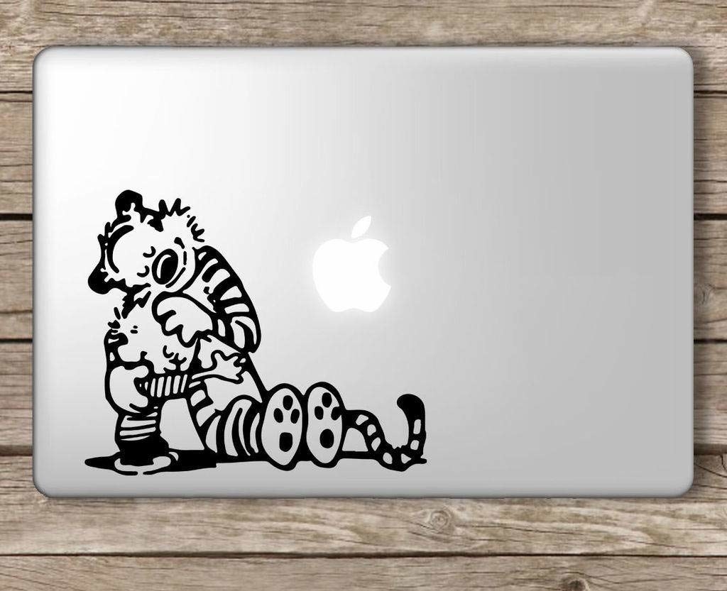 A laptop with a Calvin &amp;amp; Hobbes sticker on it