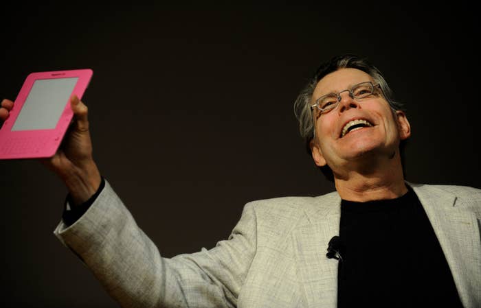Stephen King holding up an e-reader
