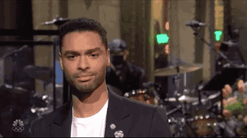 Regé-Jean Page toasting the camera during his SNL appearance