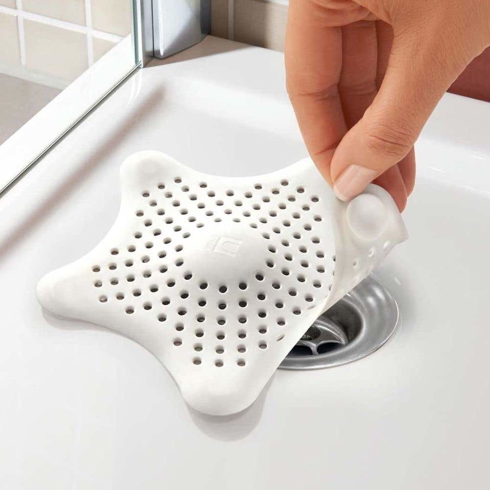 A star-shaped silicone drain cover in a tub