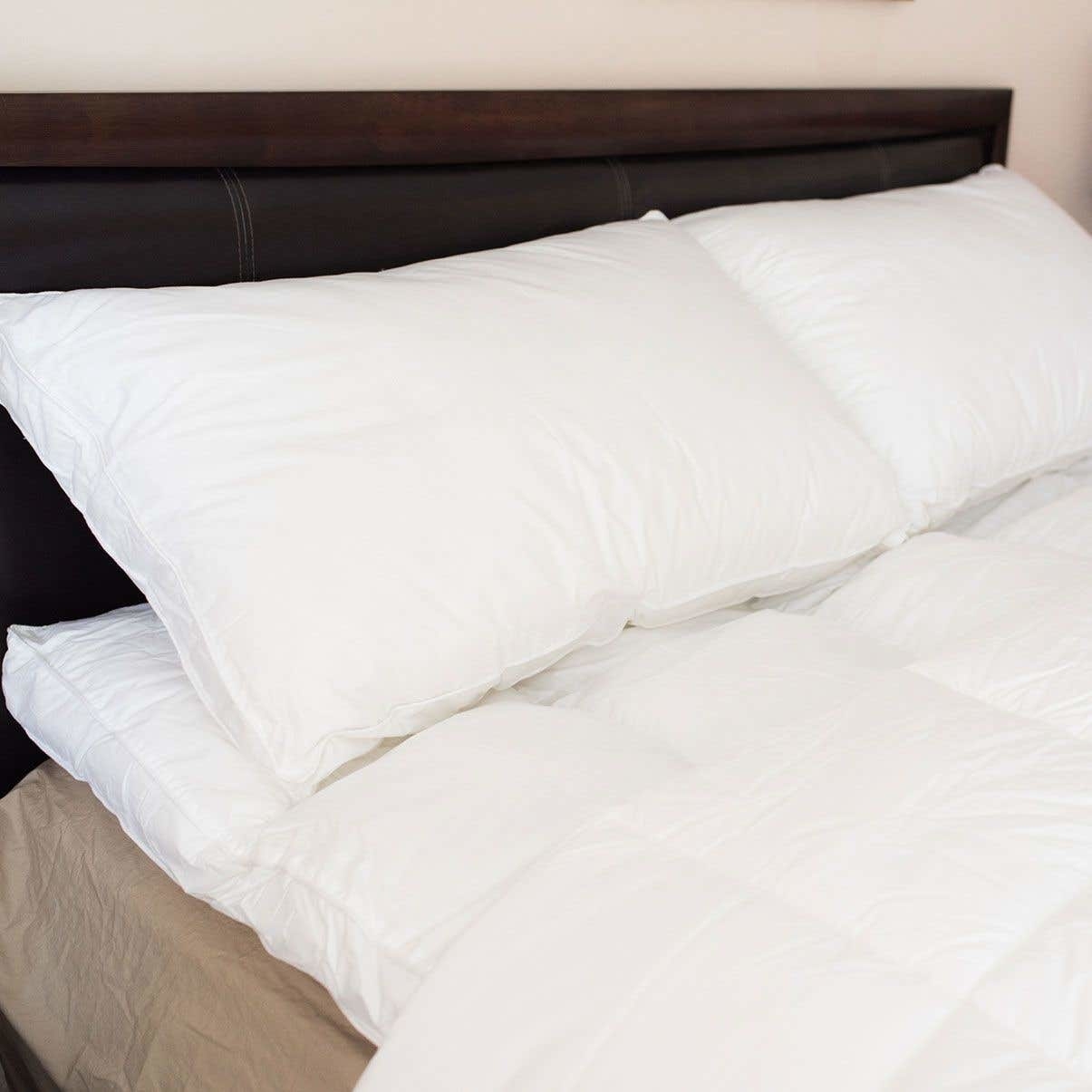 A fluffy mattress topper on a bed with pillows