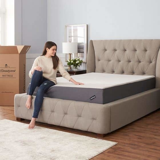 A person sitting on a thick mattress