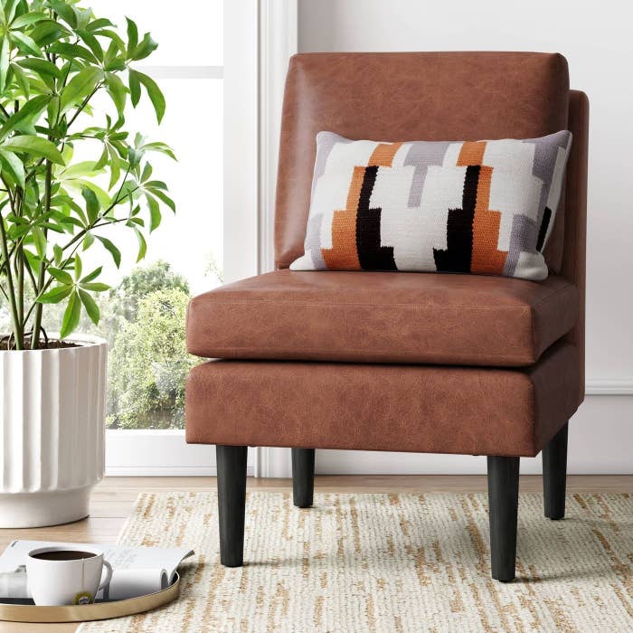 Brown rectangular leather chair with dark wooden legs
