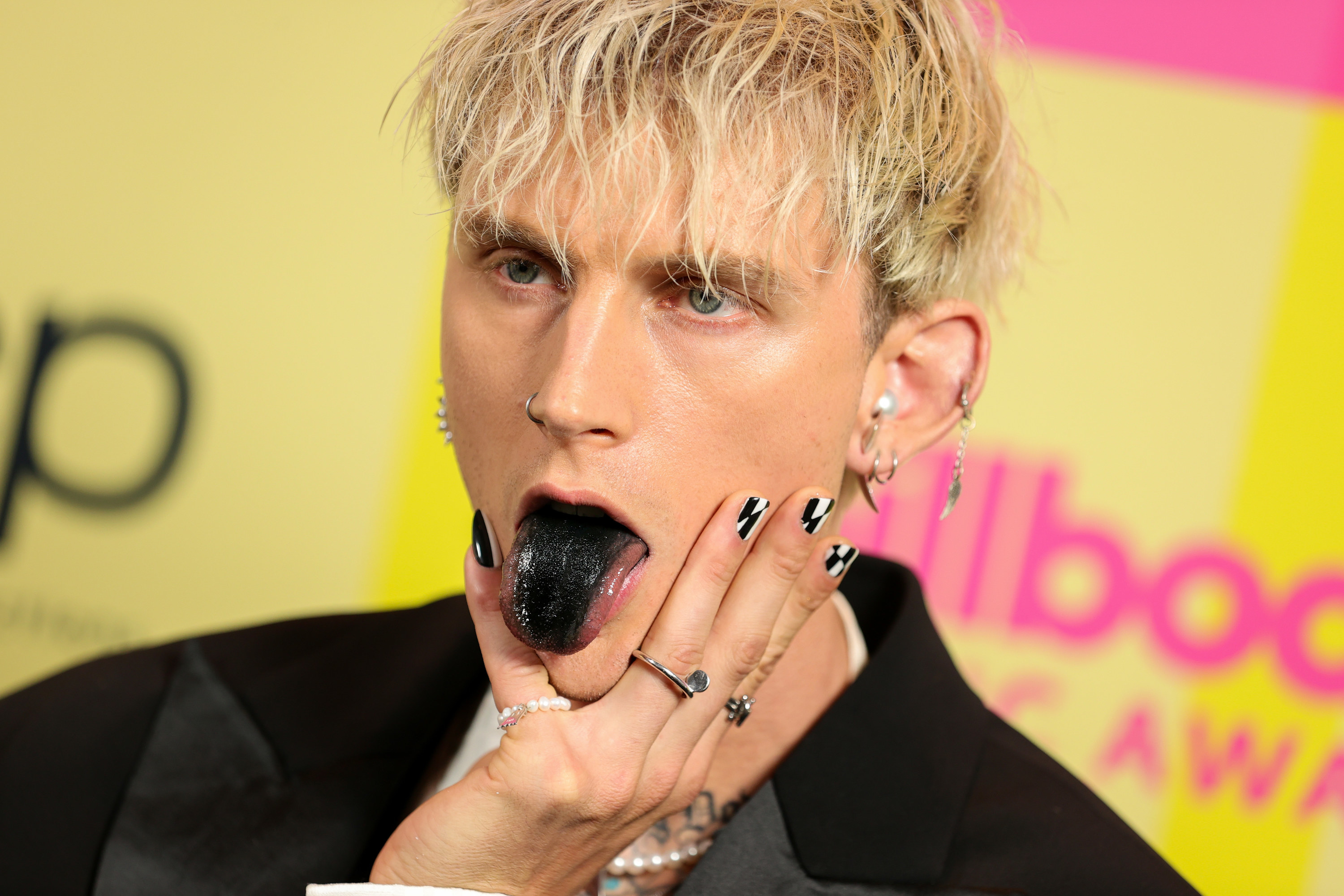 Machine Gun Kelly sticking his tongue out at the Billboard Music Awards