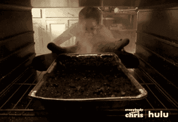 Tyler James Williams as Chris Rock on &quot;Everybody Hates Chris&quot; pulls burnt food out of the oven