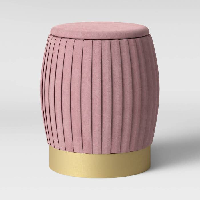 Blush pink ottoman with brass vase 