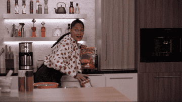 Tracee Ellis Ross as Rainbow Johnson in &quot;Blackish&quot; holding bags of snacks