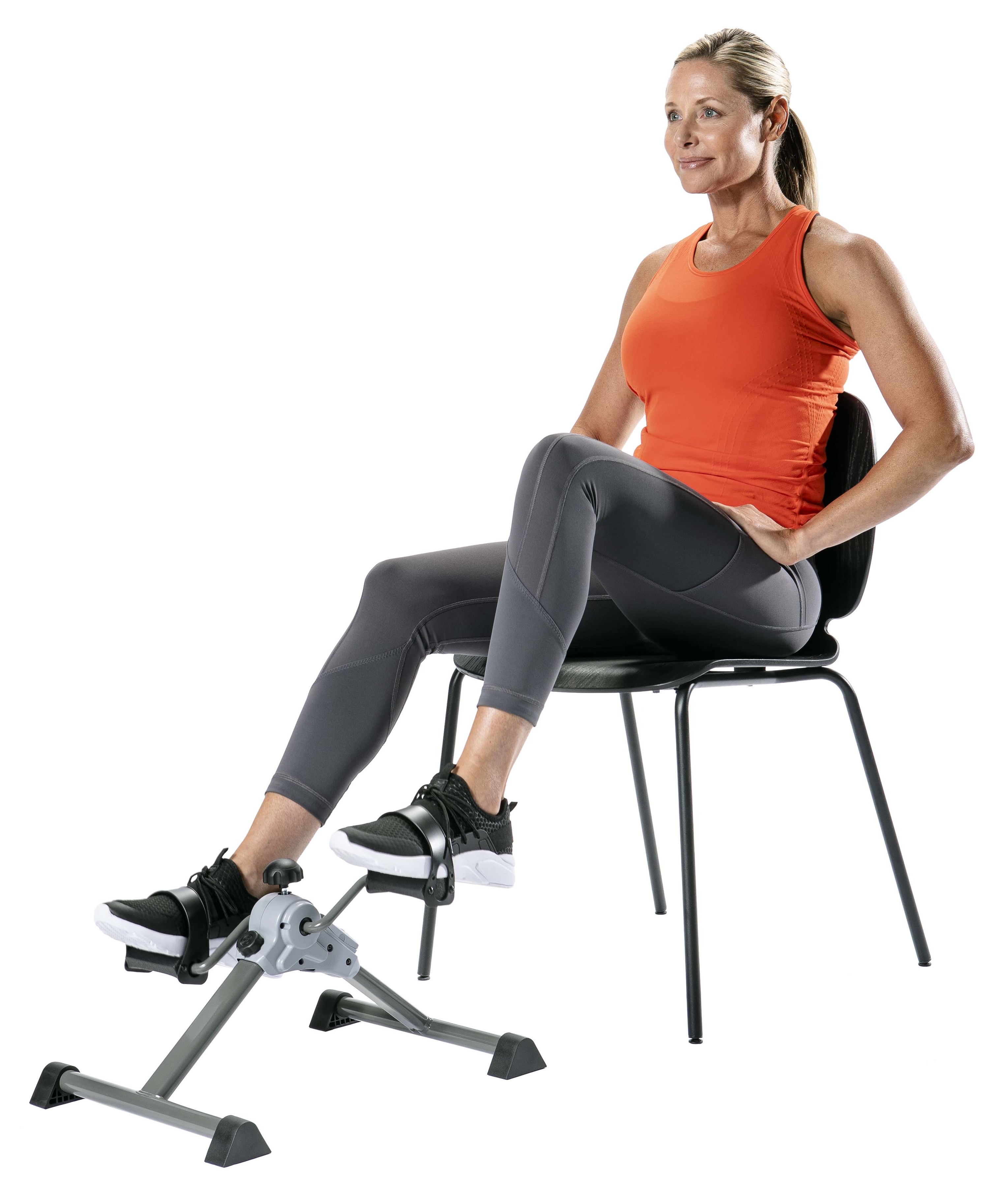 Model sitting on a chair using peddle exerciser on white background
