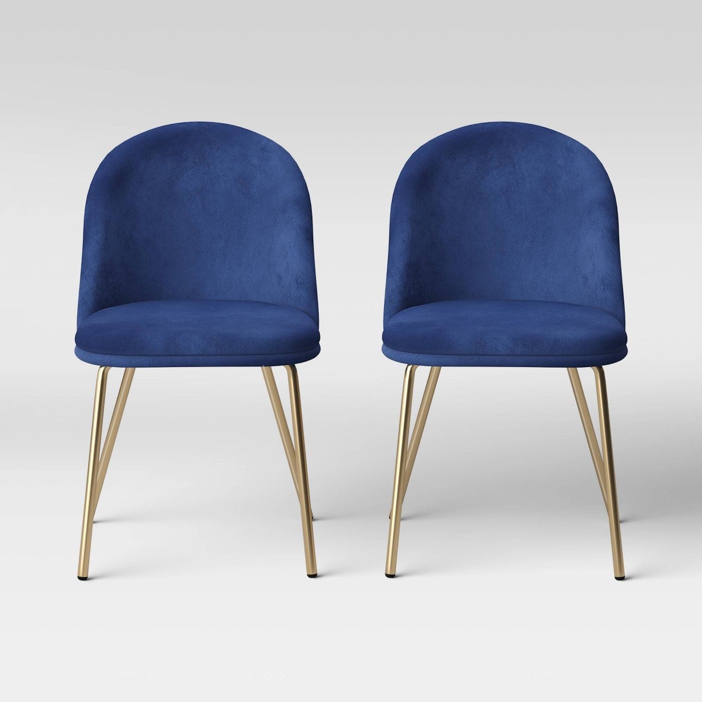Two navy blue chairs with circular with gold legs 