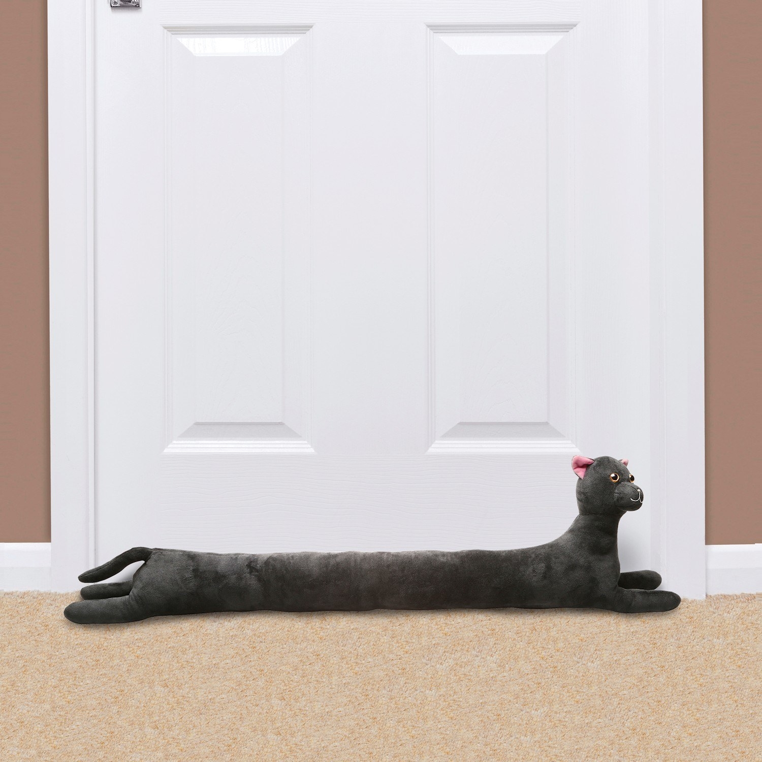 Cat style draft stopper on floor next to door