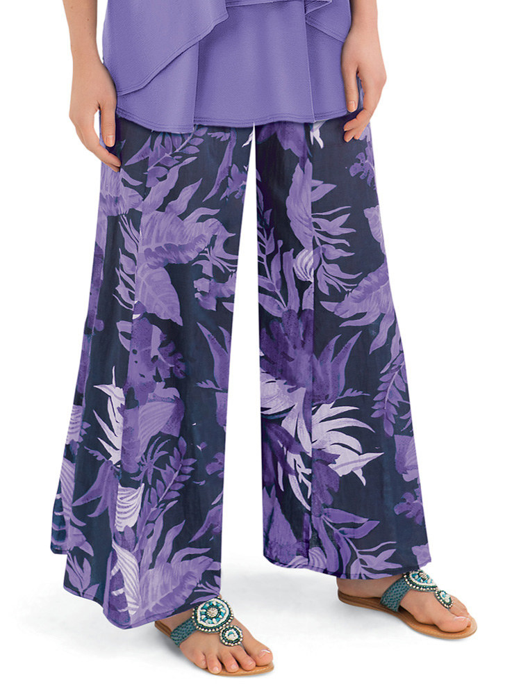Model wearing floral pants and sandals