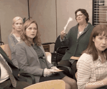gif of phyllis from the office fanning herself flirtatiously 