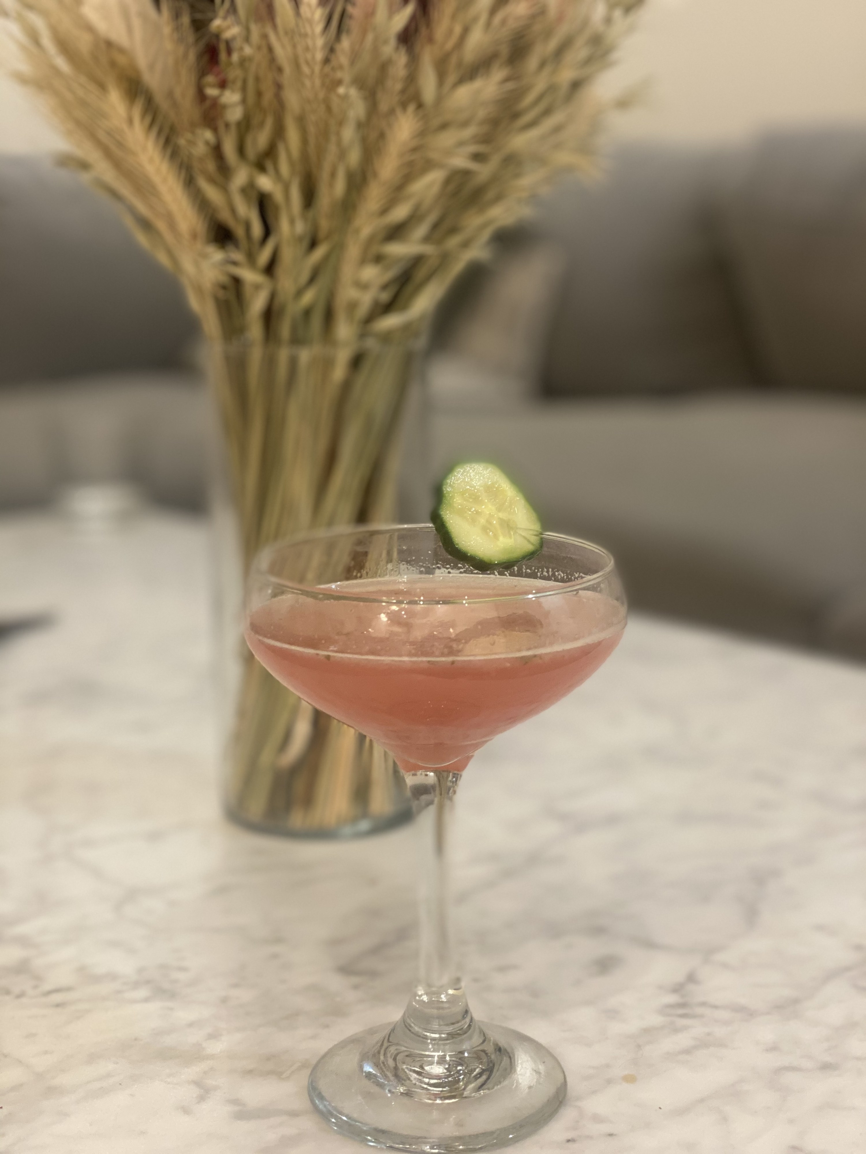 A booze-free Cosmopolitan garnished with a cucumber.