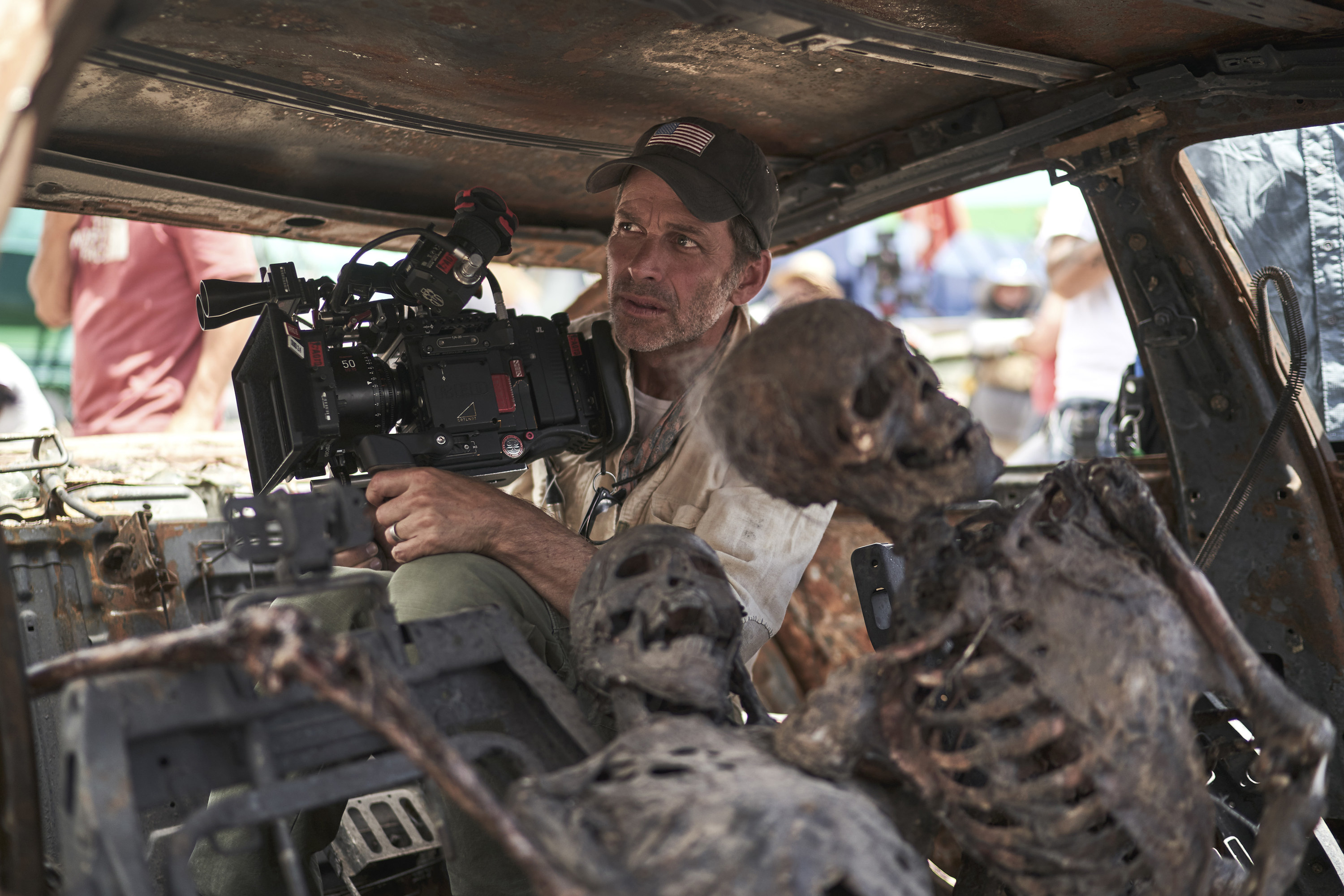 Zack sitting inside a car with a skeleton as he shoots a scene