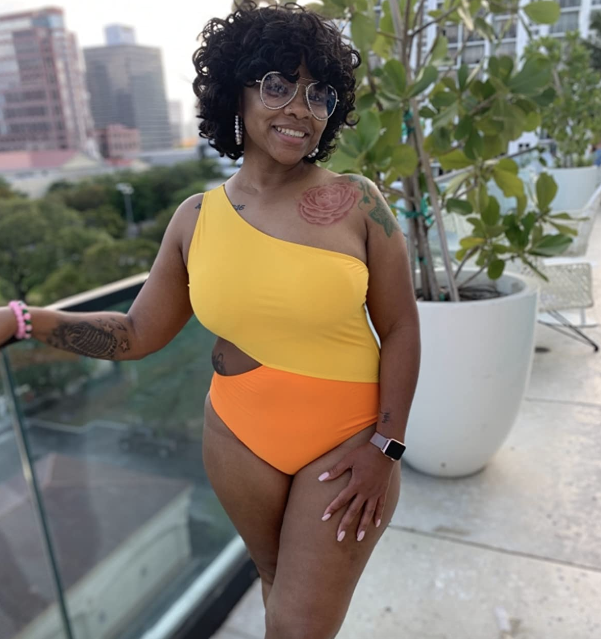 reviewer wearing the yellow and orange swimsuit 