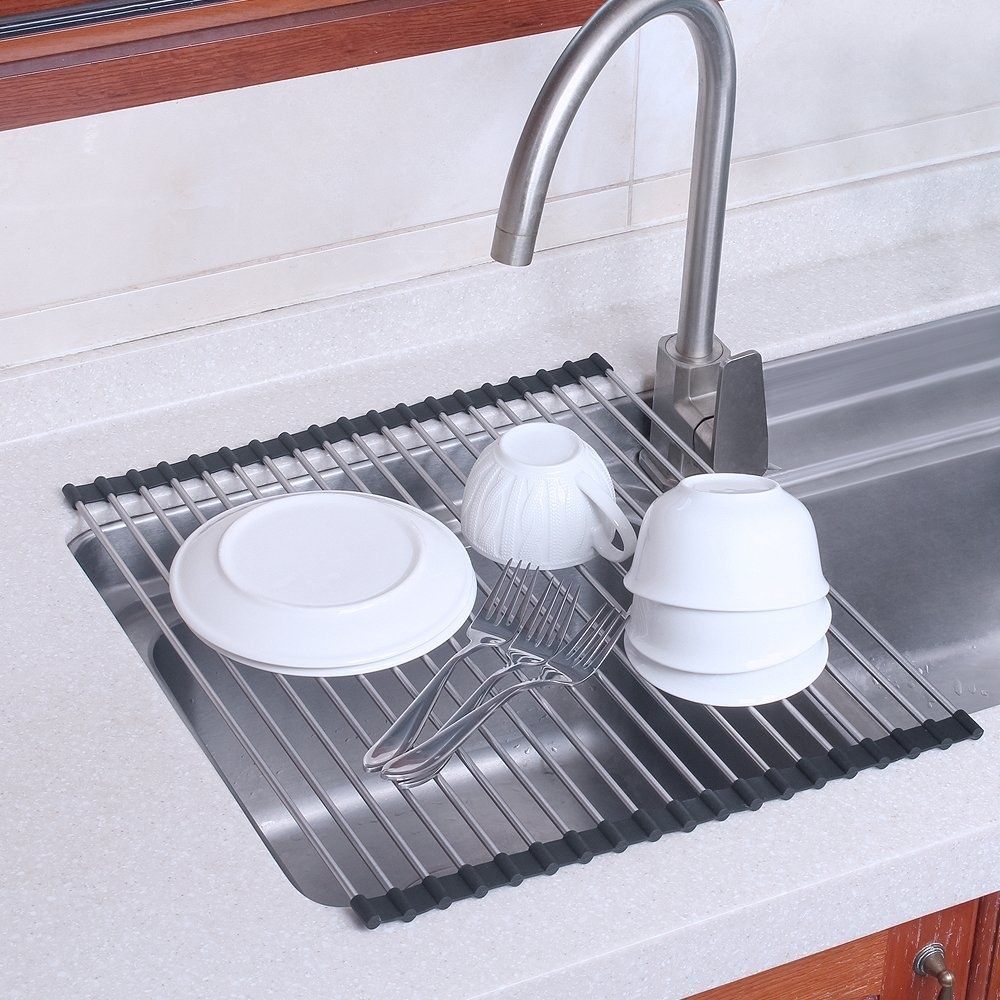 small bowls and plates drying on the foldable silicone over-the-sink drying rack
