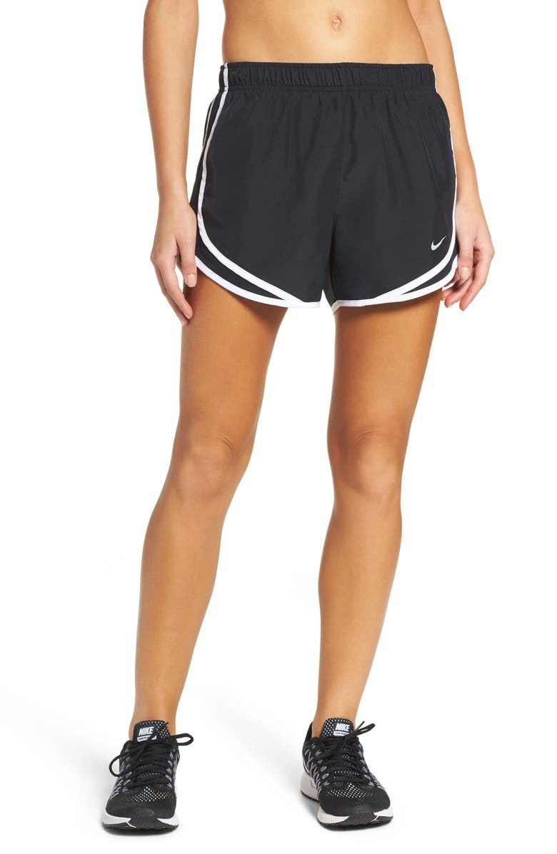 A model wears the shorts in black with white piping