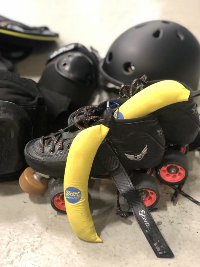 A set of black roller skates with yellow boot bananas inside