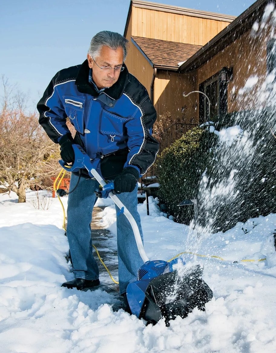 a person using the electric snow shovel