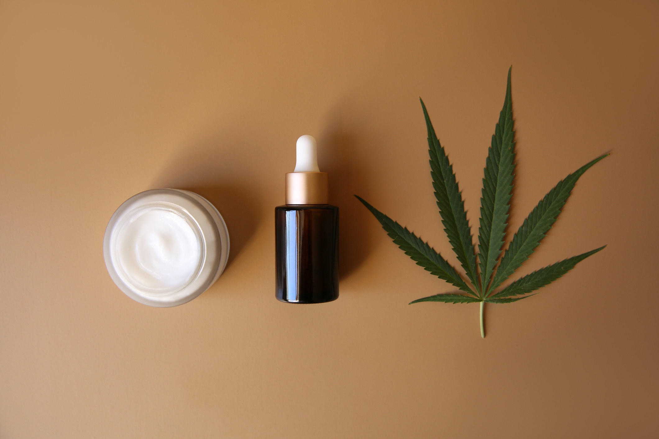 CBD lotion, oil, and a hemp leaf