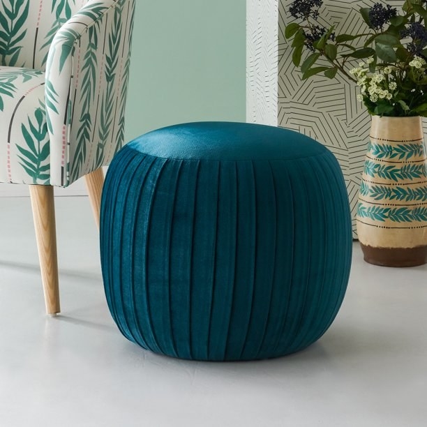 The ottoman in the color peacock blue