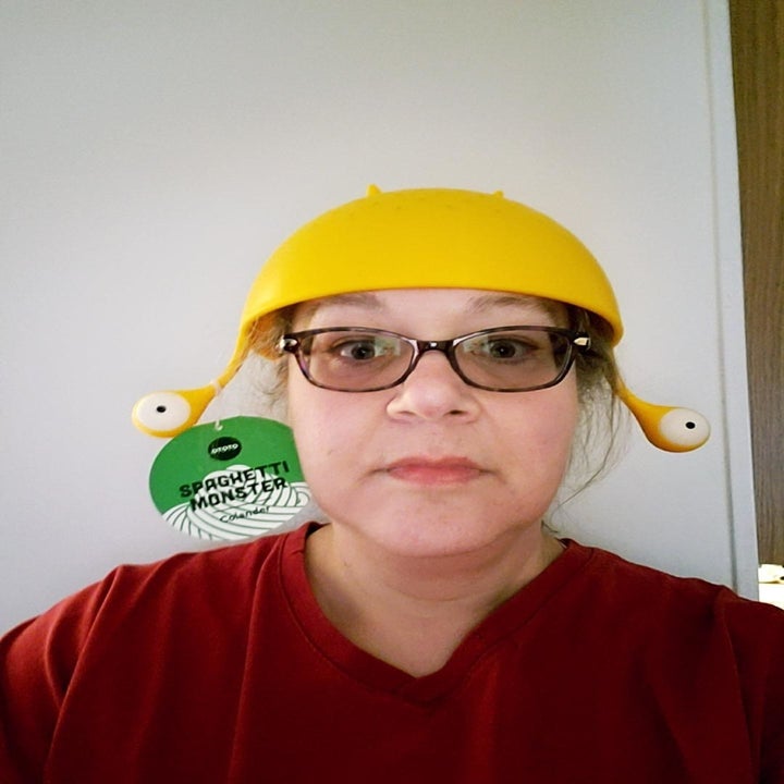 Reviewer wearing Spaghetti Monster on their head