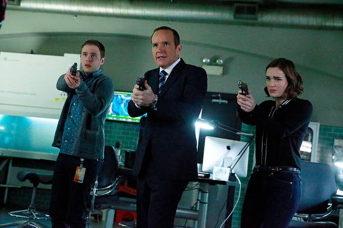 The cast of Agents of SHIELD holding guns