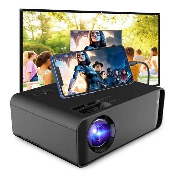 a small black movie projector with a smartphone attached 