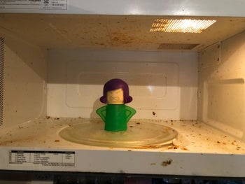 reviewer photo of a dirty microwave before using the angry mama microwave cleaner