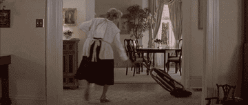 Mrs. Doubtfire dancing as she vaccuums
