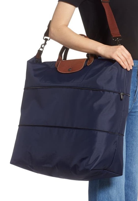 A model holds the bag in navy