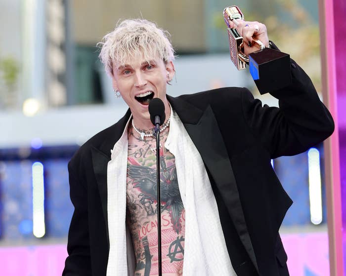 MGK holds up his award