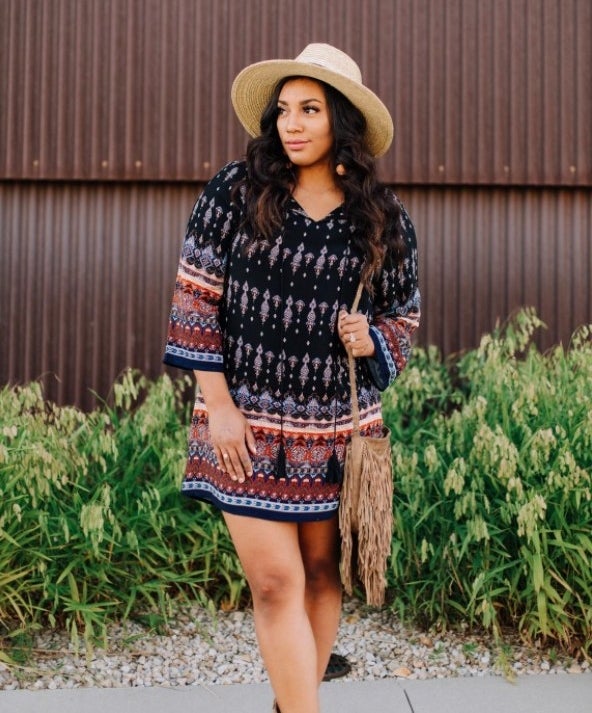 a reviewer wearing the dress with a sunhat