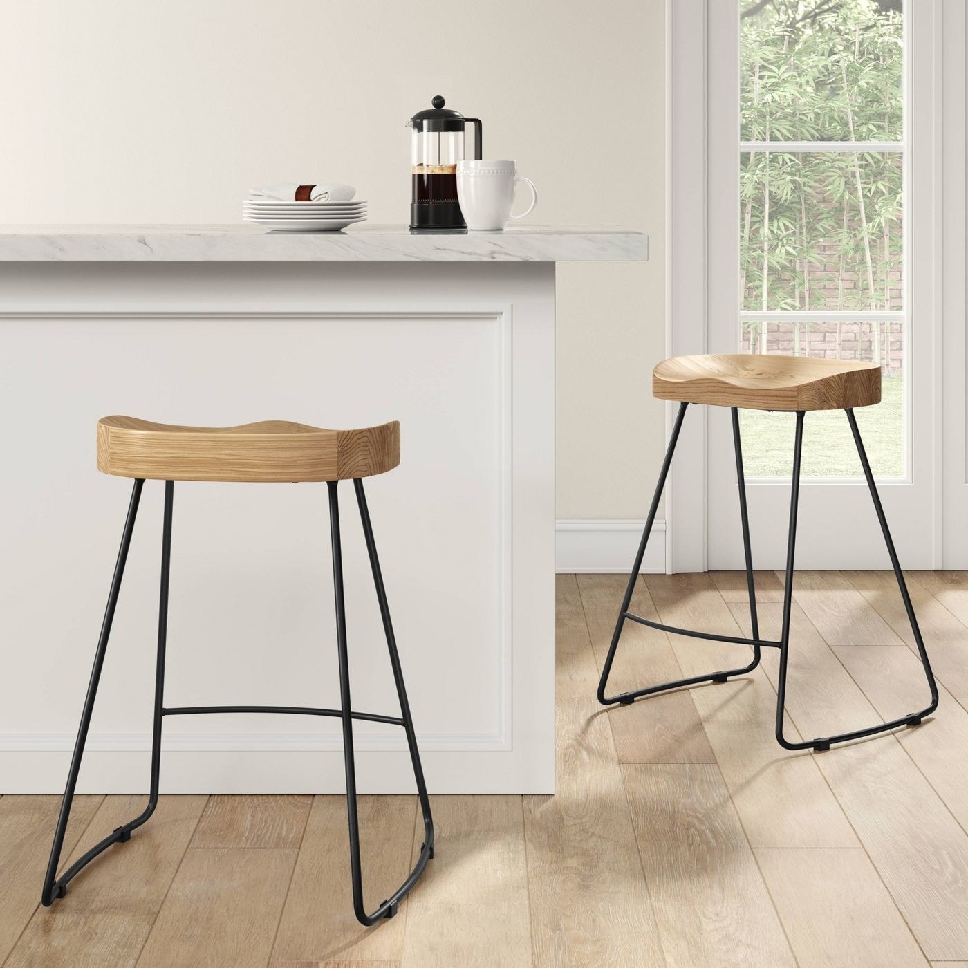 Two stools with oak seats and black legs 