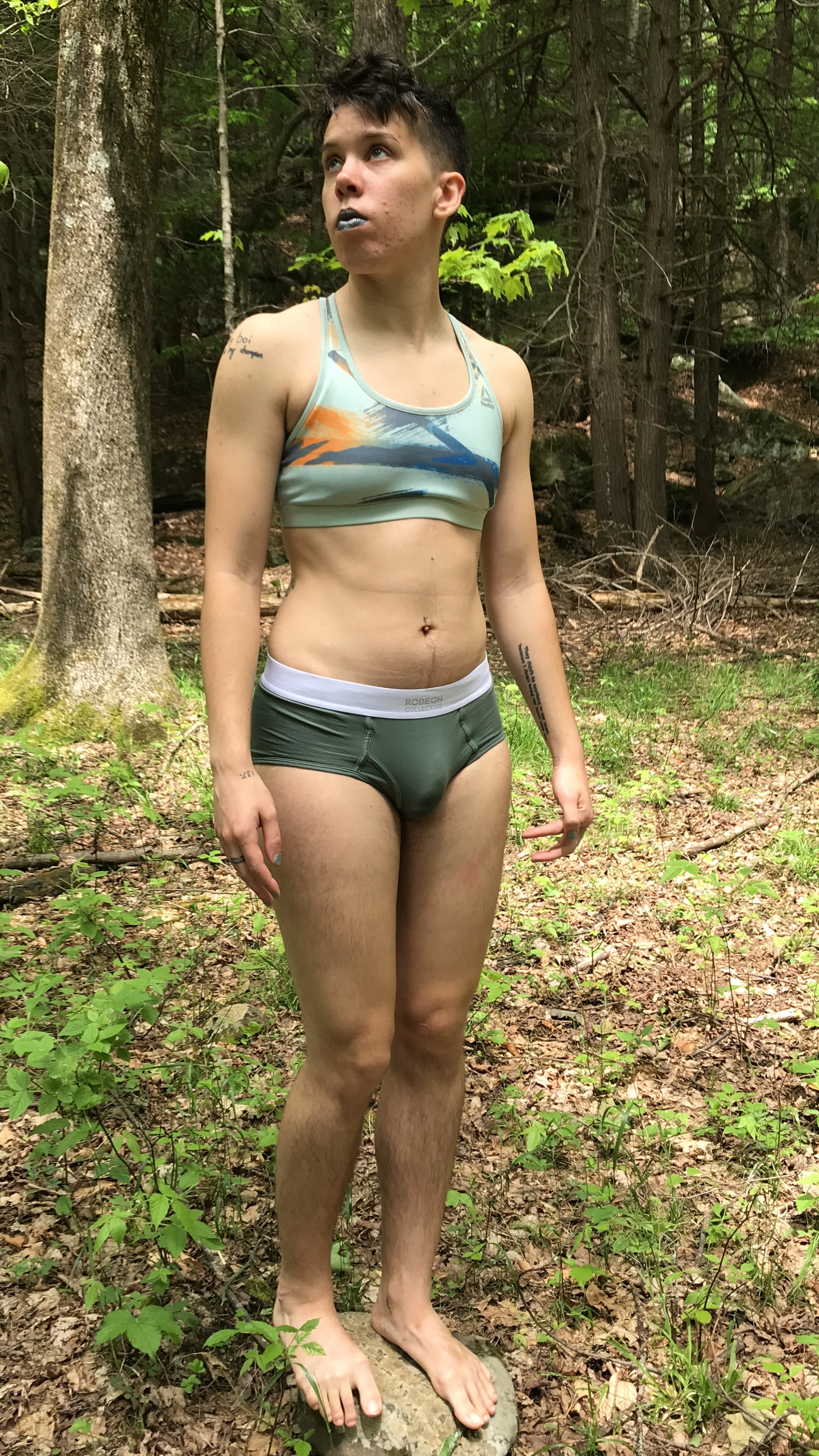A trans person in the forest