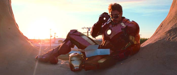 Tony Stark lowering his sunglasses inquisitively