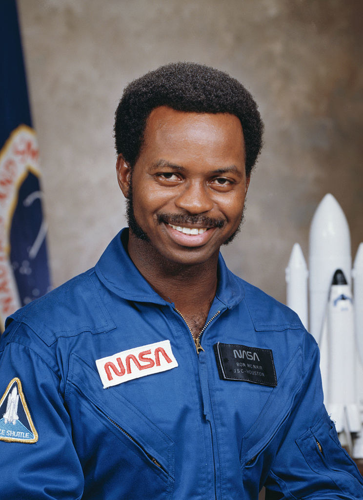 Ronald McNair posing for a photo in his NASA jumpsuit