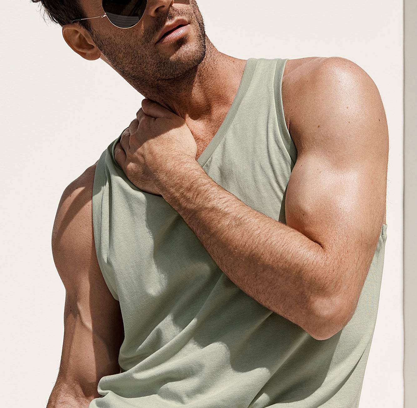 A person wearing the sunglasses and a tank top